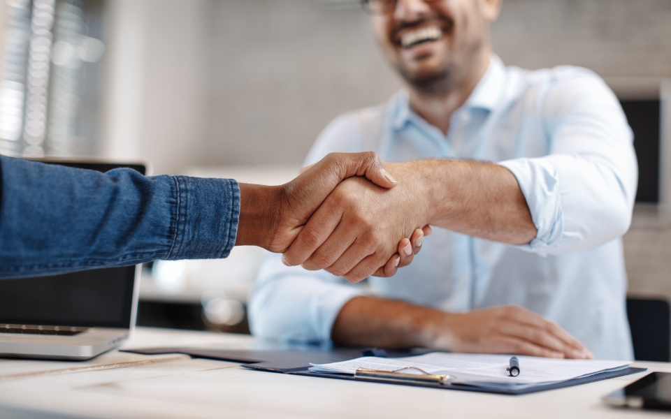 An image of a person shaking hands with another person.